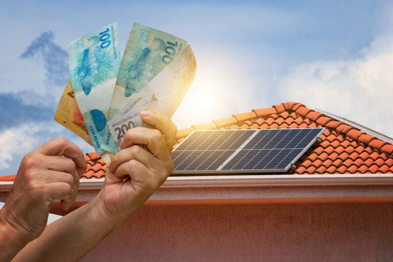 solar energy economy holding brazilian money front photovoltaic panel roof sunset background space text scaled 1